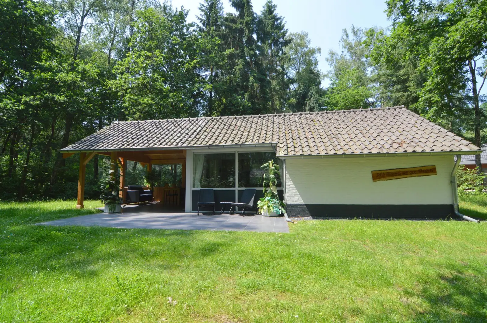 The bungalow and veranda from the lawn, in summer