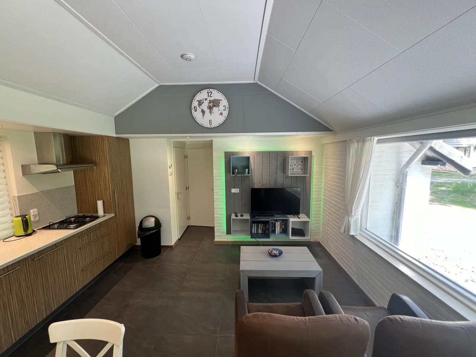 Kitchen and seating area in one room under the sloping ceiling