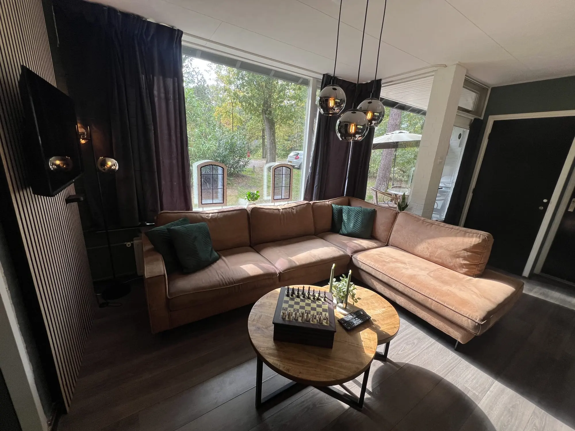 Corner sofa by the big windows, coffee table with a chess set