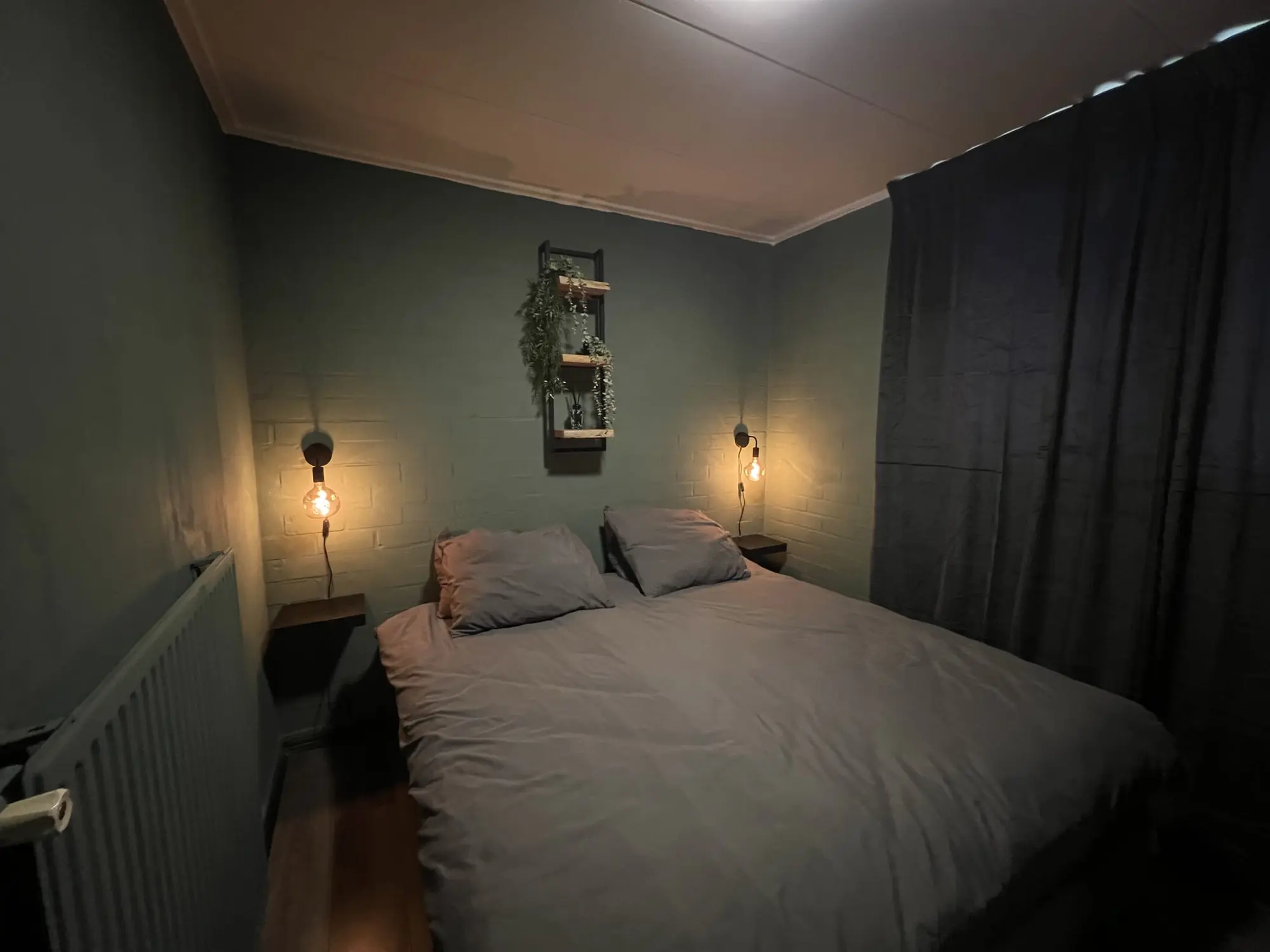 Bedroom with a double bed and wall lights