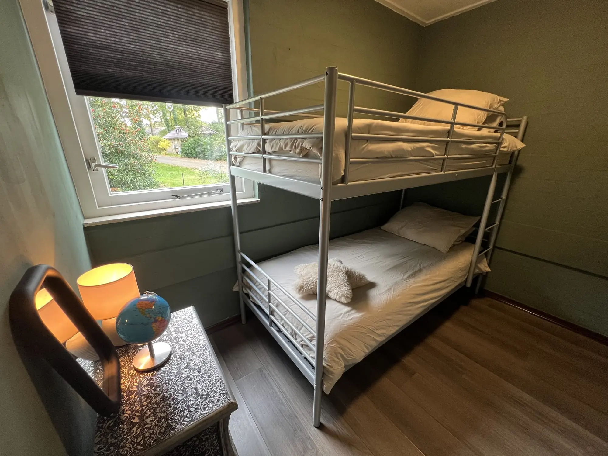 Bedroom with a bunk bed, lamp and globe