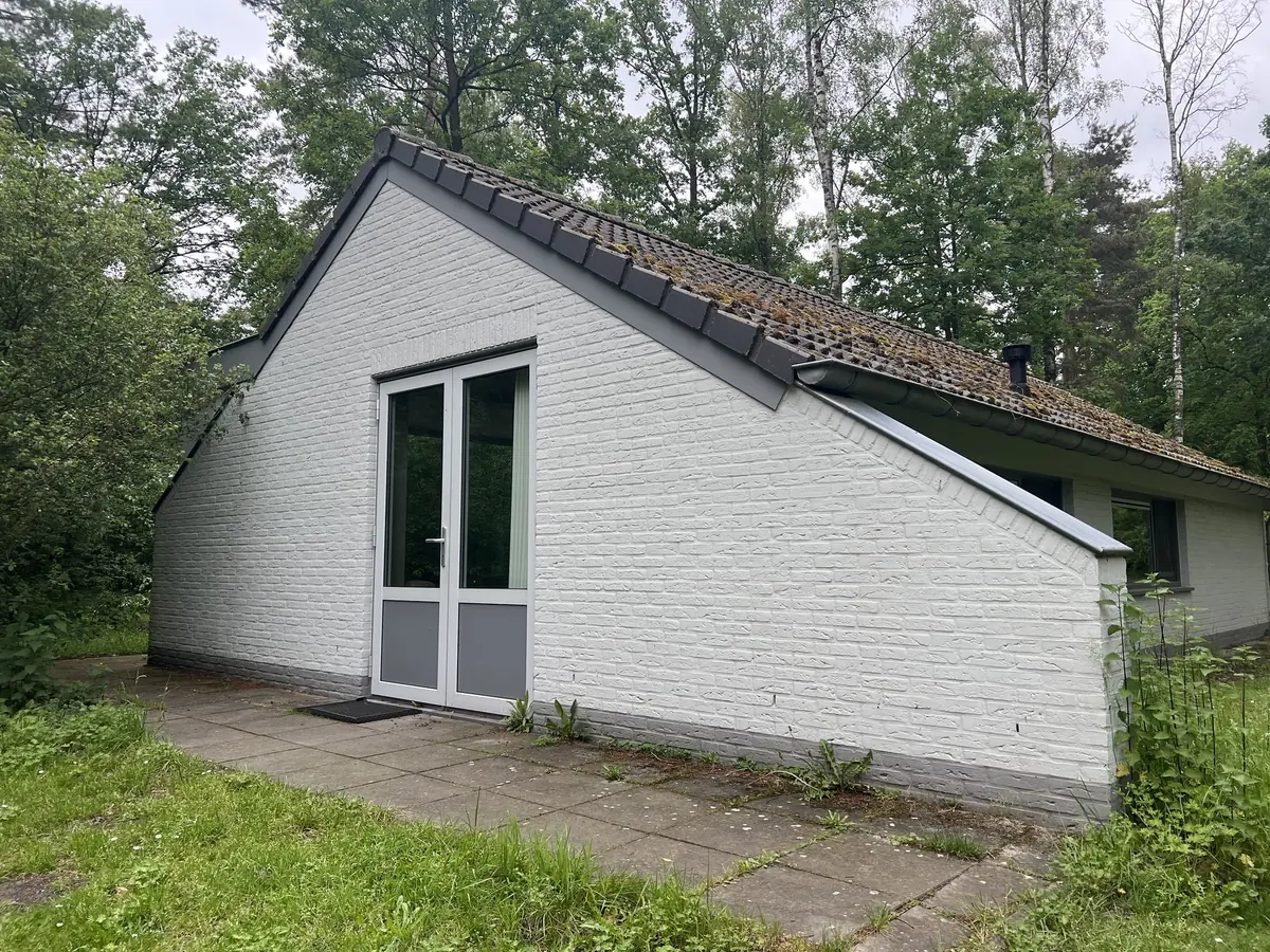 The white gable end with double glass doors onto the terrace