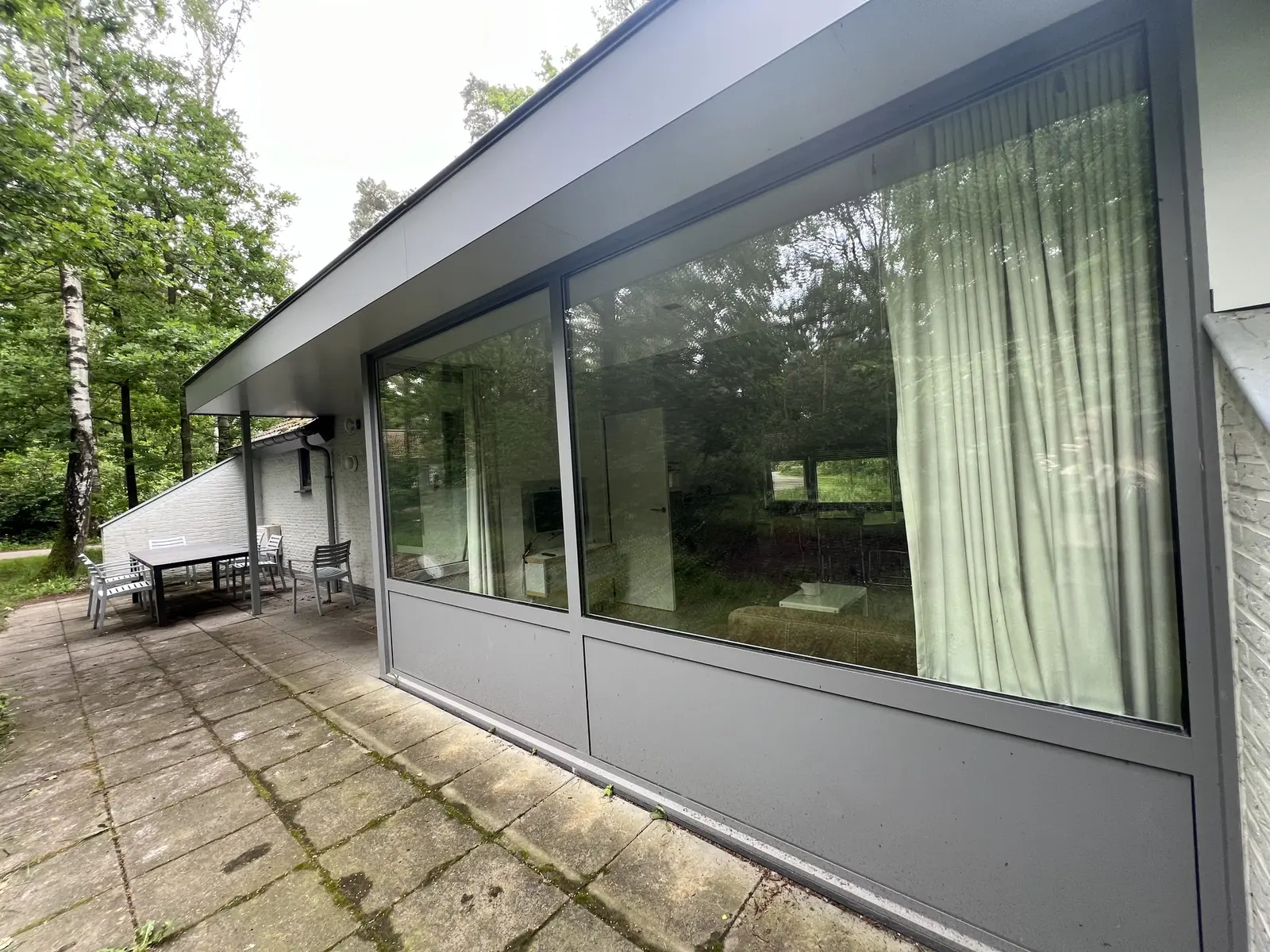 The large living-room windows, with the terrace alongside
