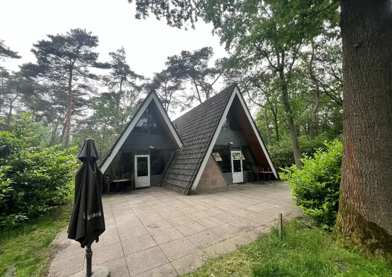 The same two chalets in summer, with parasol