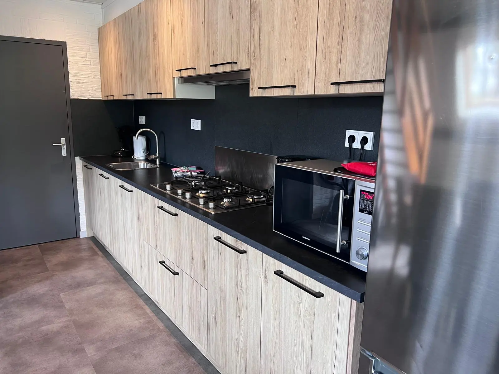 Kitchen with gas hob and microwave