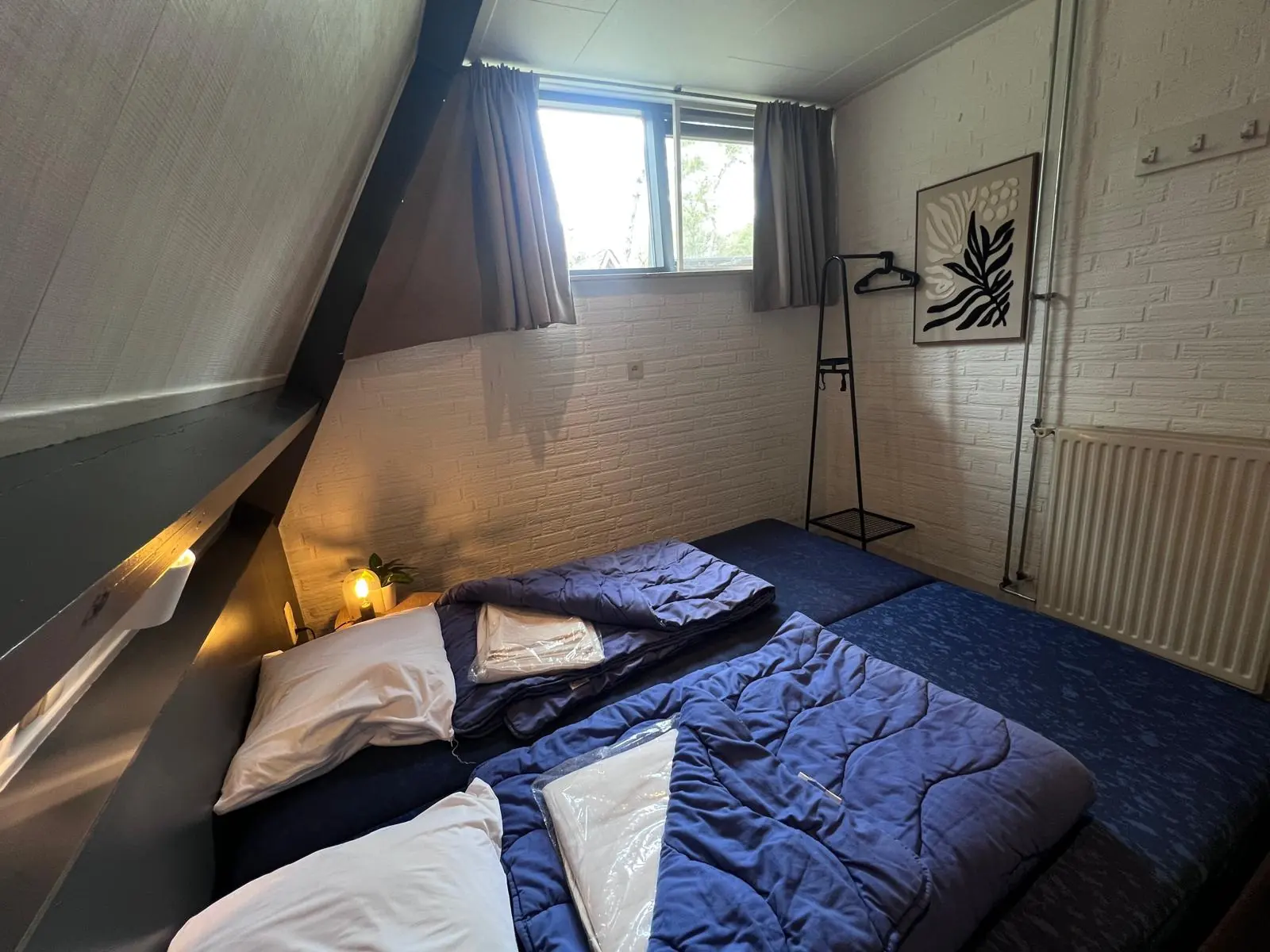 Bedroom under the sloping wall, blue bedding